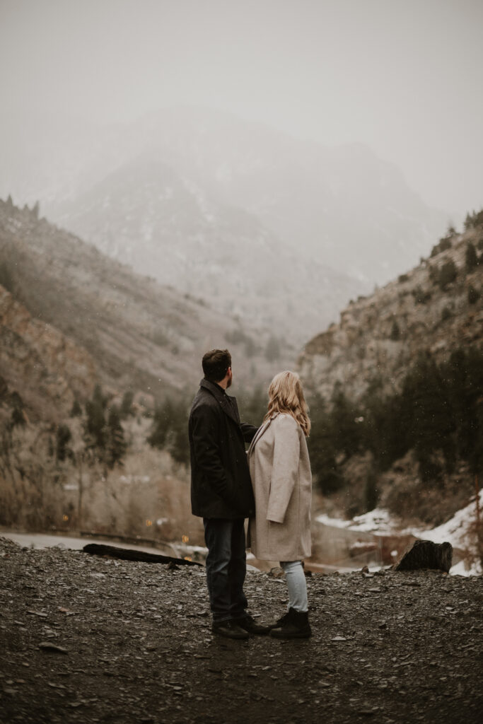 Couple walking around the mountains taking engagement photos