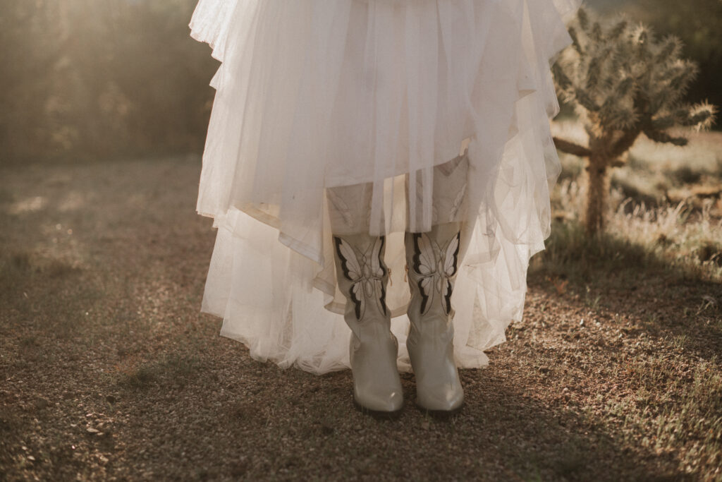 White cowgirl boots with butterflies on them