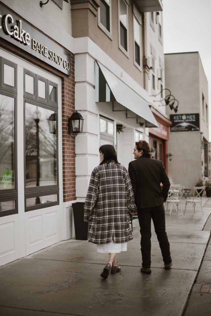 Couple walking the streets in the rain after a proposal.