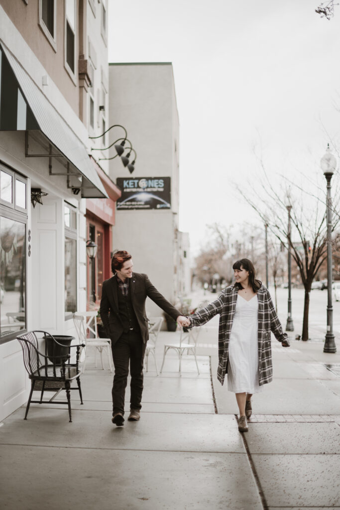 Couple dancing in the rain for a photoshoot after a proposal.