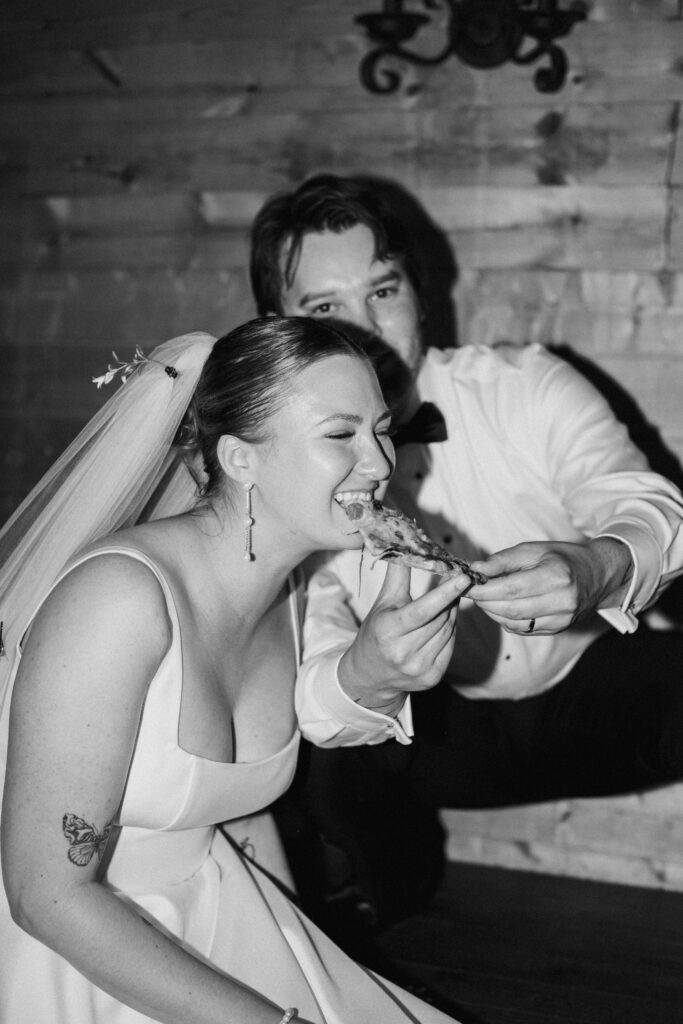 Bride and groom eating pizza
