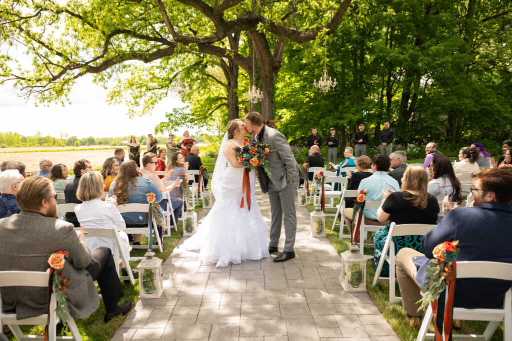 Bride and Groom kiss walking down the isle after the wedding ceremony.