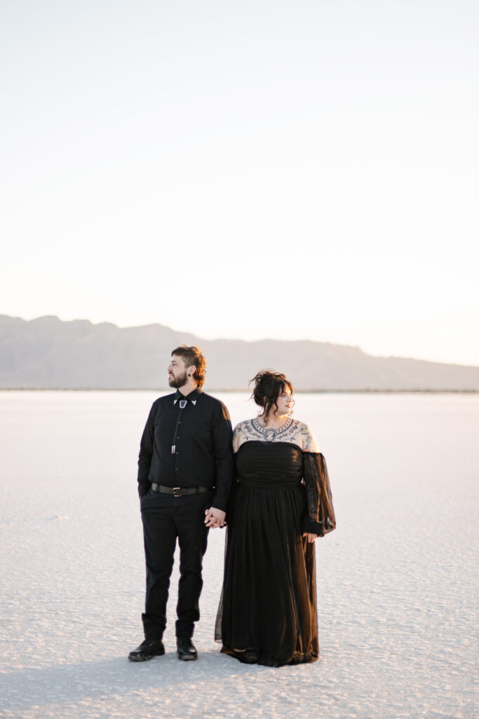 Engagement session at the Utah Salt Flats in all black outfits. 