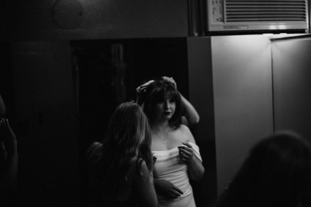 Black and white photo of the bride getting ready for the ceremony.