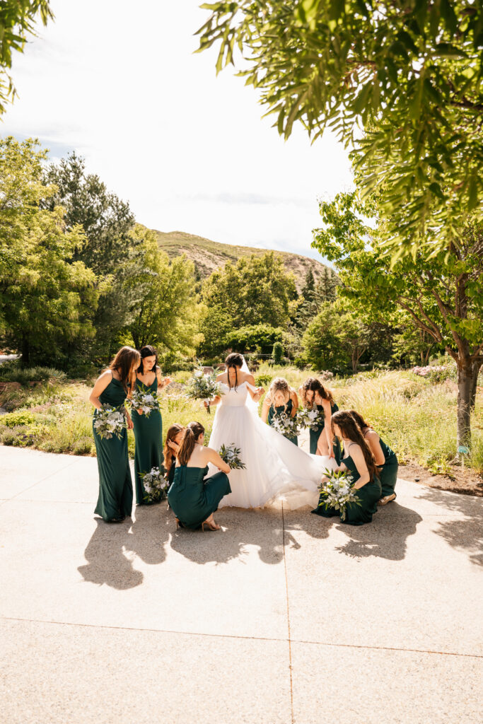 Bridal party fixing the bride's dress