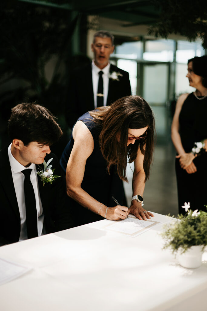 Bride and groom signing marriage certificate