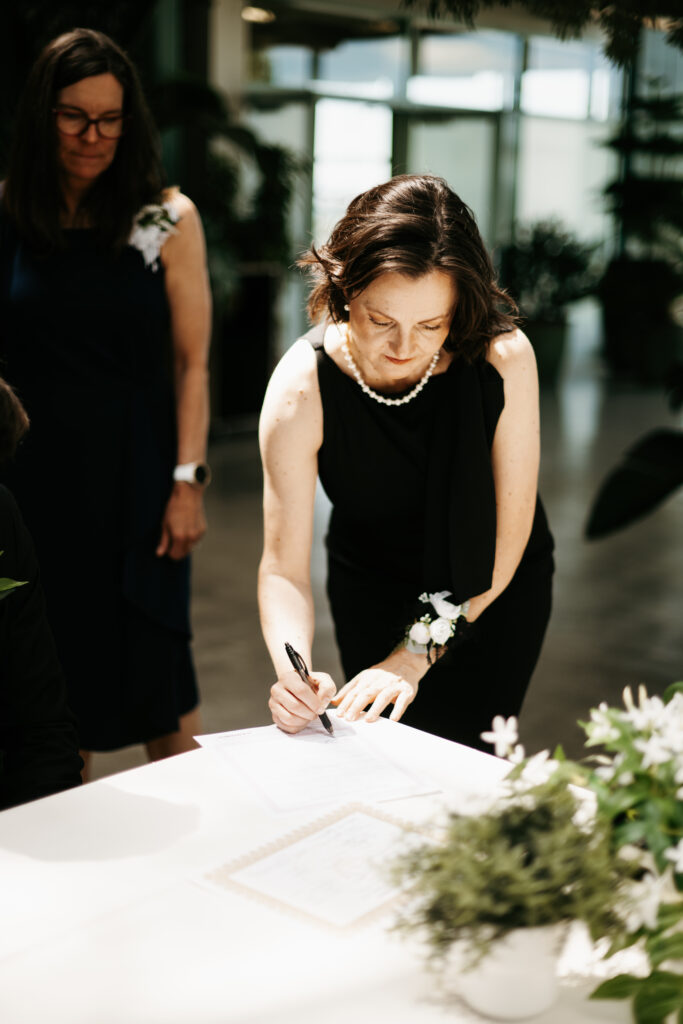 Bride and groom signing marriage certificate