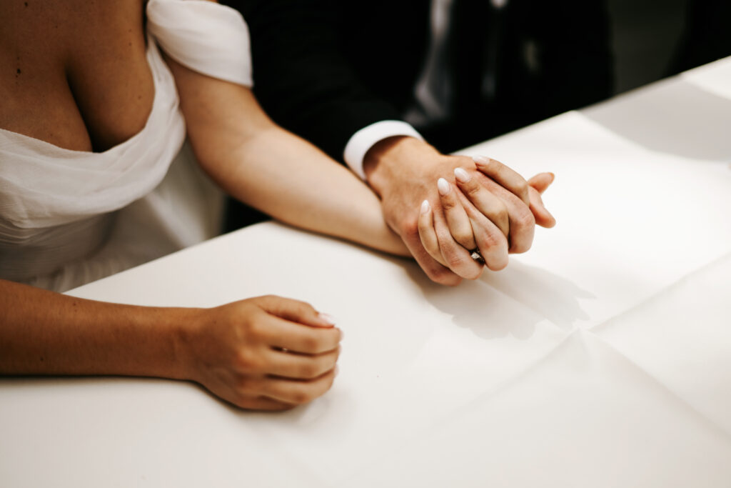 Bride and groom signing marriage certificate