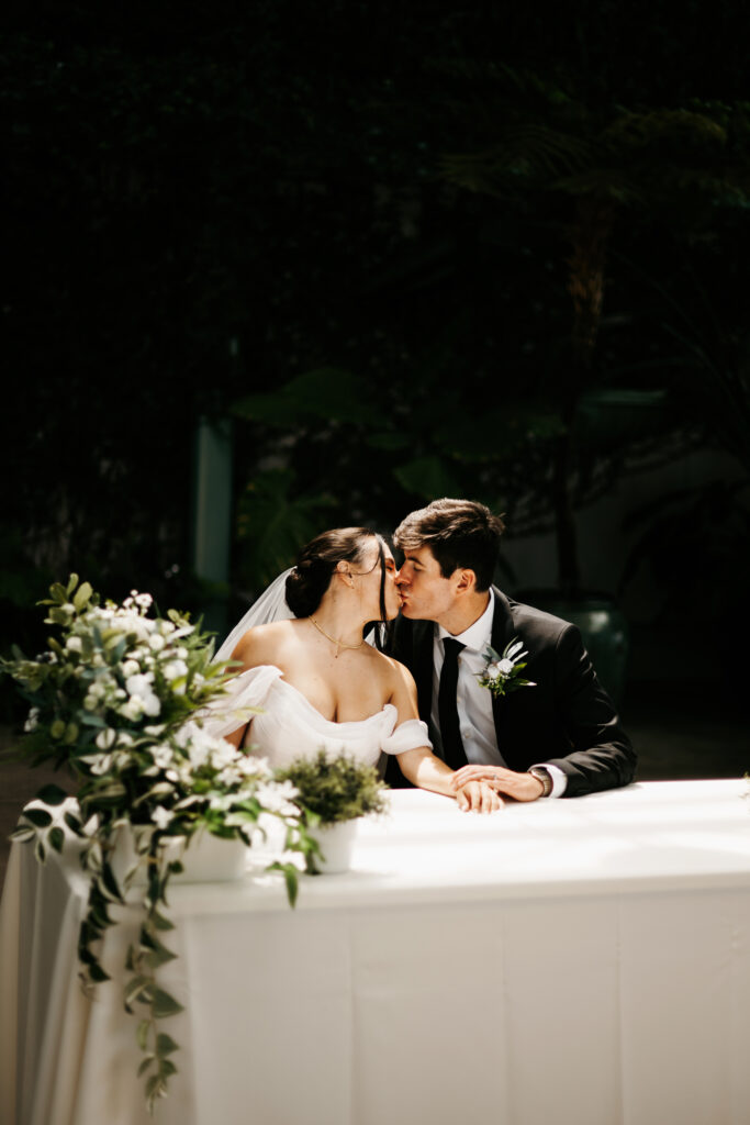 Bride and groom signing marriage certificate