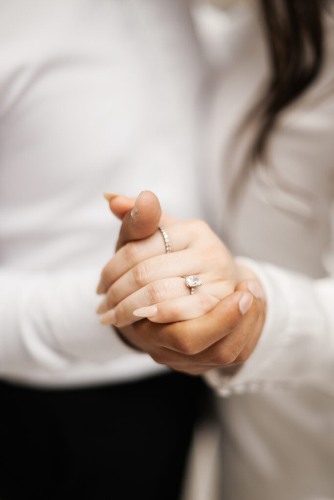Engagement ring photos with both people wearing white