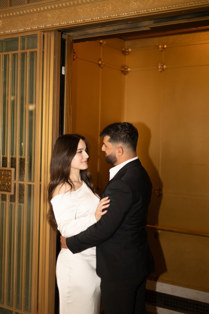 Engagement phots in a gold elevator