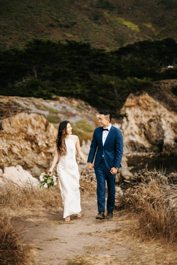 Bride and groom exchanging vows on a cliffside in Big Sur, California.
