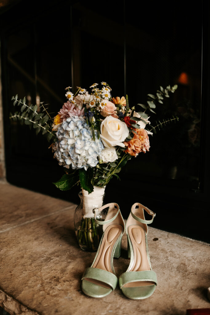Rustic wedding detail flat lay photos with green wedding shoes