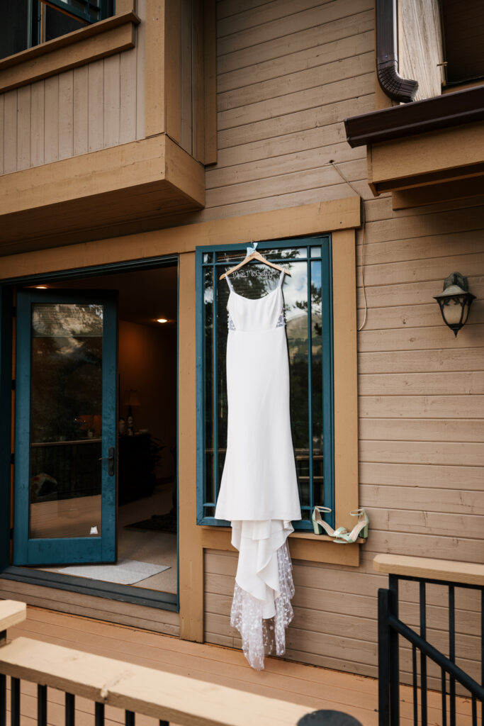 Wedding dress hanging on a cabin window