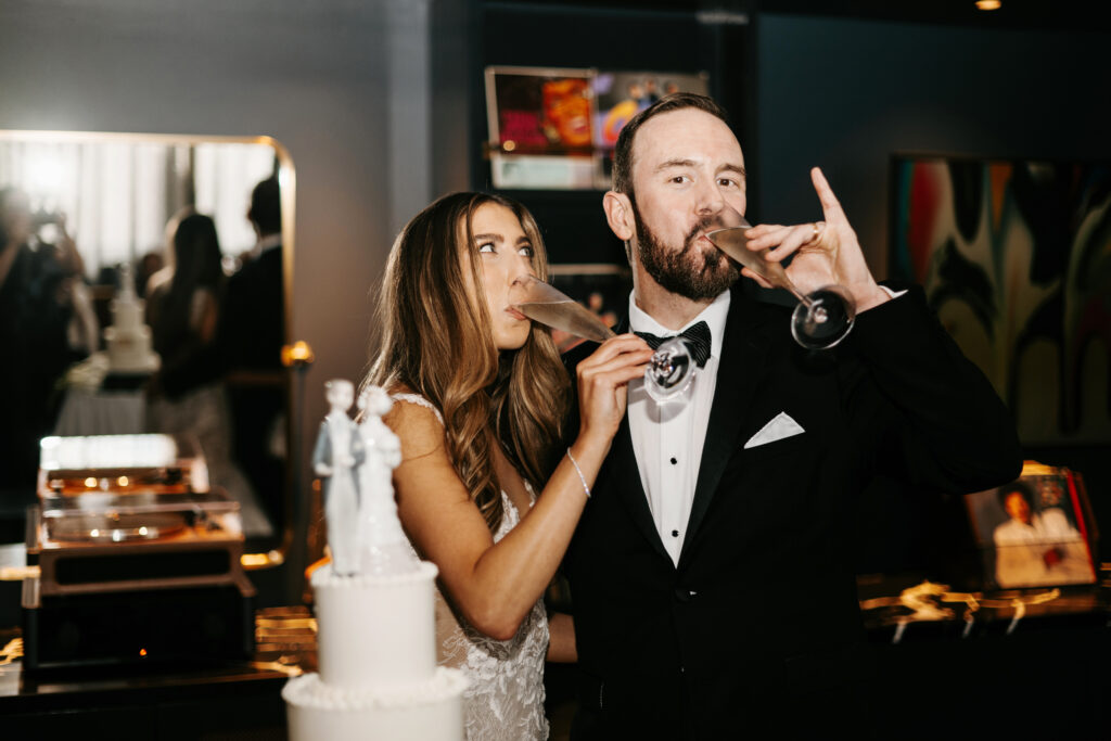 Bride and groom cutting cake with vintage cake topper