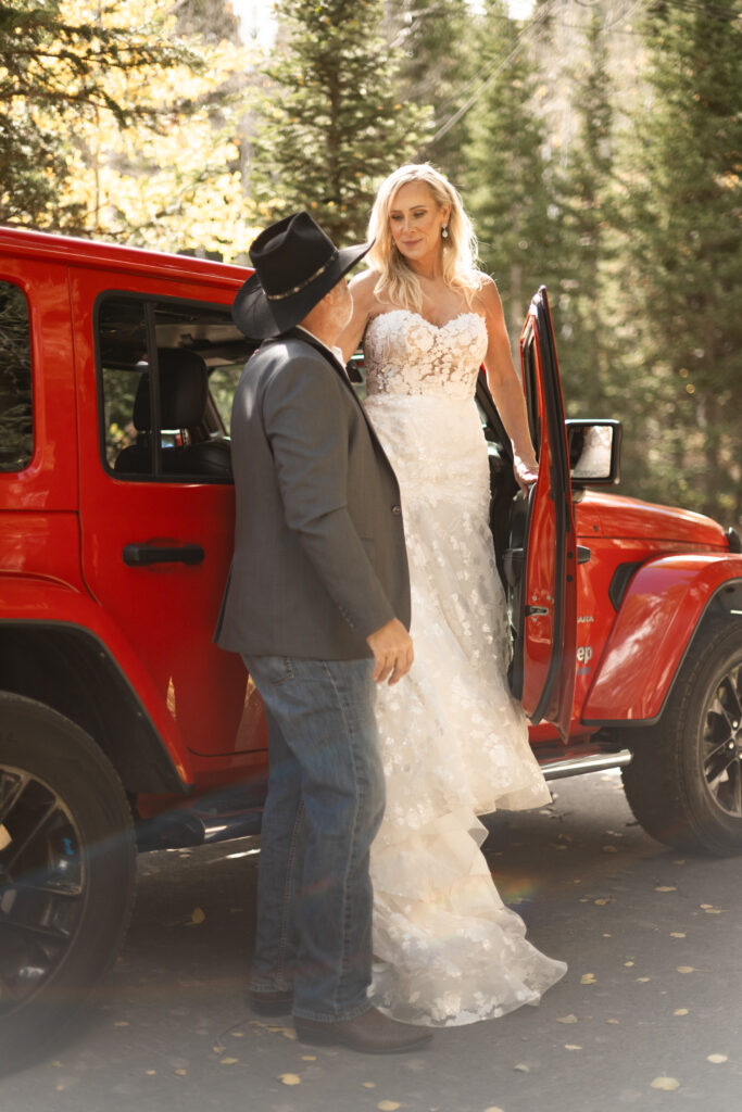 Bride and Groom in a Red Jeep