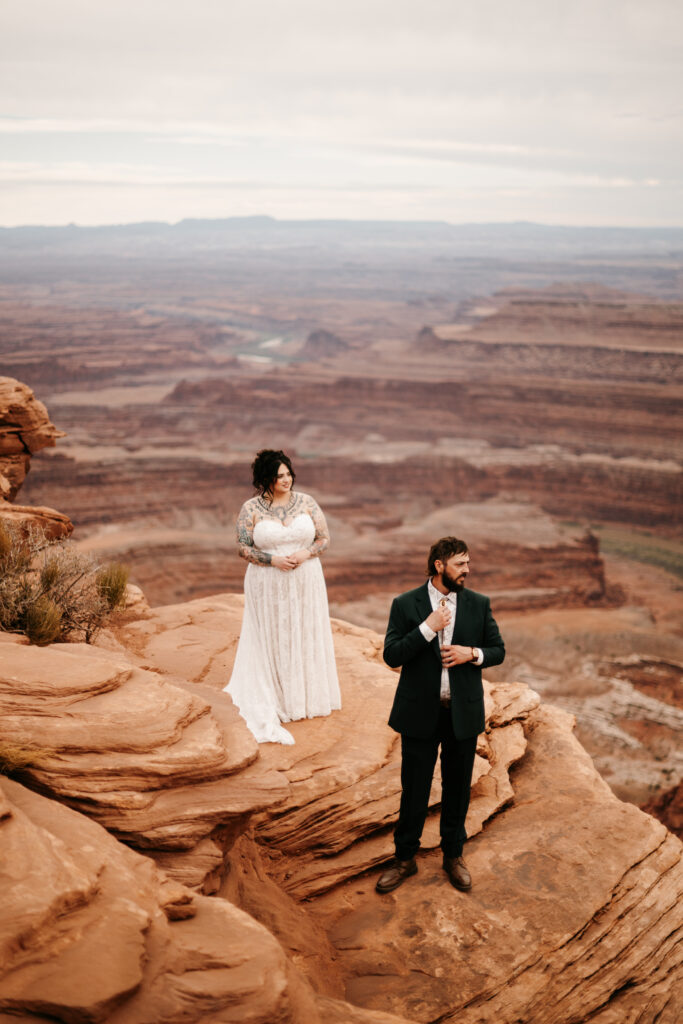 Bride and Groom standing on a cliff edge