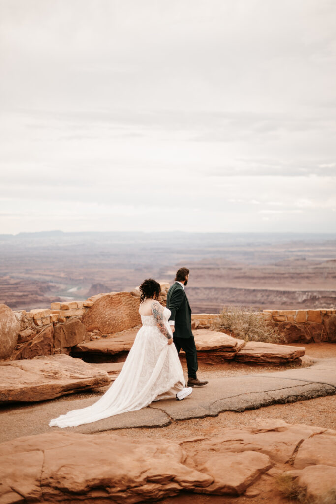 Bride and Groom standing on a cliff edge