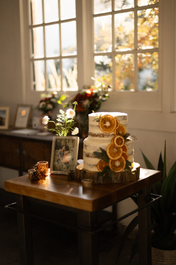 Simple wedding cake with orange slices on it.