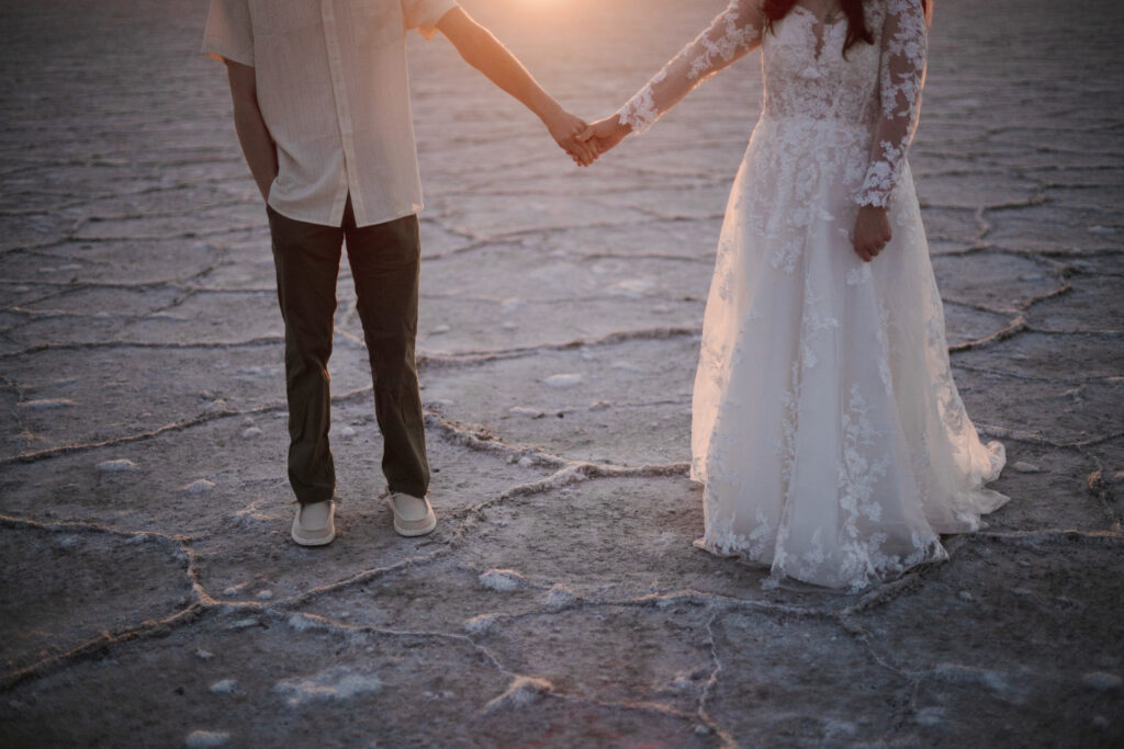 Sunrise bridal portraits at the Bonneville Salt Flats with soft pastel sky