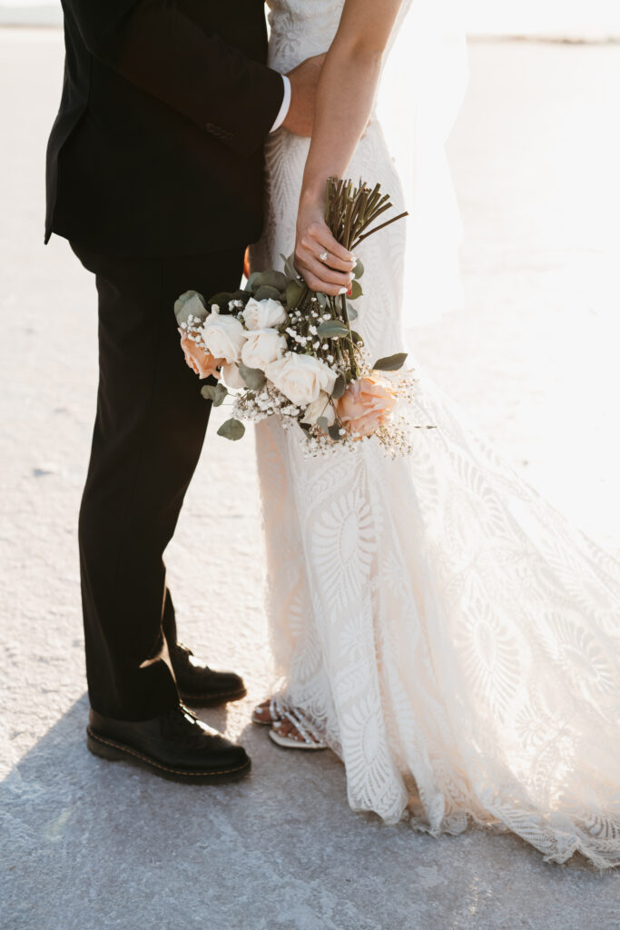 Utah elopement photographer capturing couple at Bonneville Salt Flats during golden hour