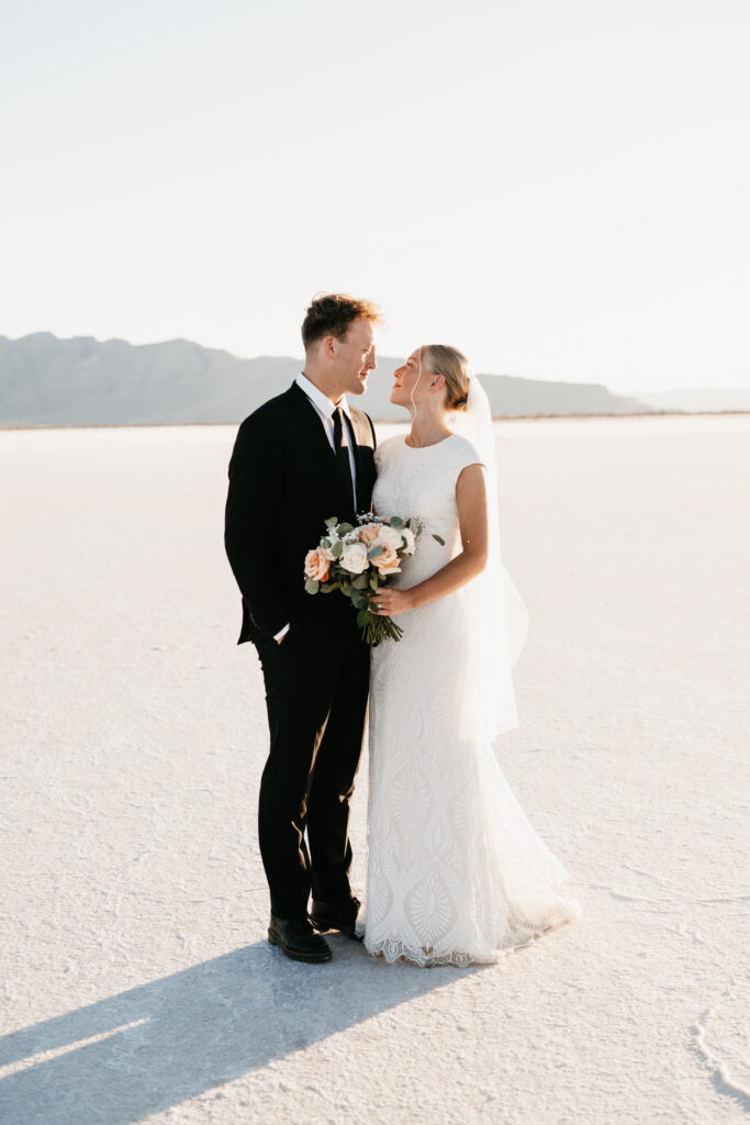 Romantic Bonneville Salt Flats wedding ceremony setup with minimal arch and desert backdrop