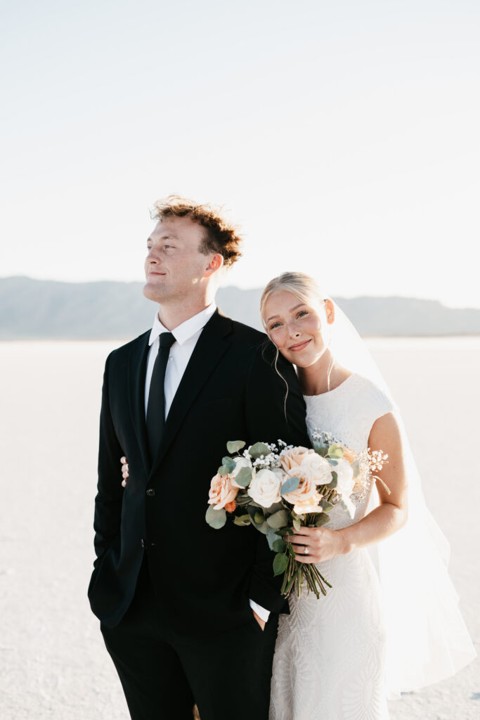 Couple holding hands on the Bonneville Salt Flats during a Utah elopement