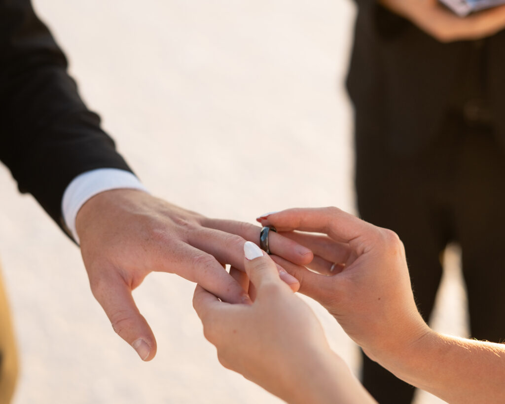Intimate elopement ceremony at Bonneville Salt Flats in Utah with officiant and couple