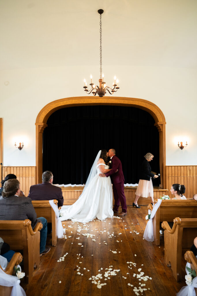 Bride and Groom getting married at the chapel in  This Is The Place Heritage Park Wedding Venue