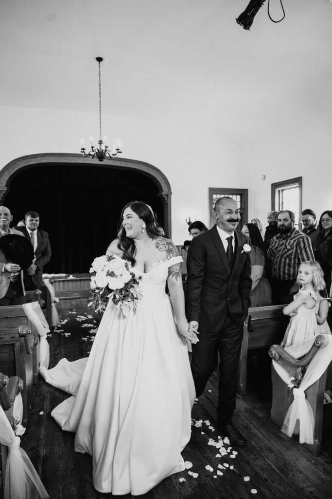 Bride and Groom walking down aisle
