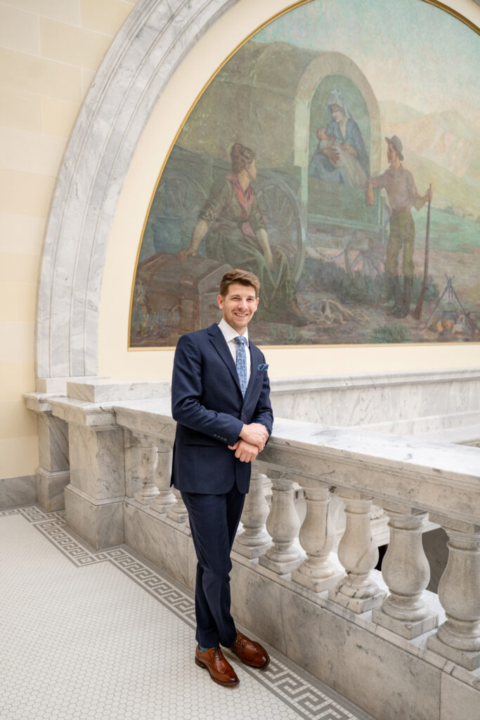 Groom photos before a first Look at the Utah State Capitol Building